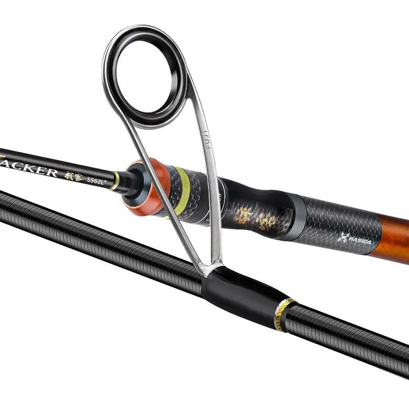 Close-up of HISTAR Hacker fishing rod showing FUJI guide and carbon fiber handle for smooth casting.