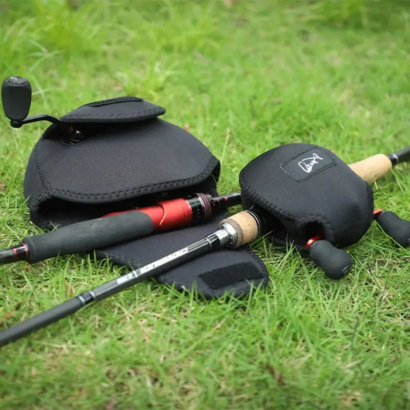 LINNHUE portable fishing reel bags and rods on grass, waterproof protection for spinning and baitcasting reels.