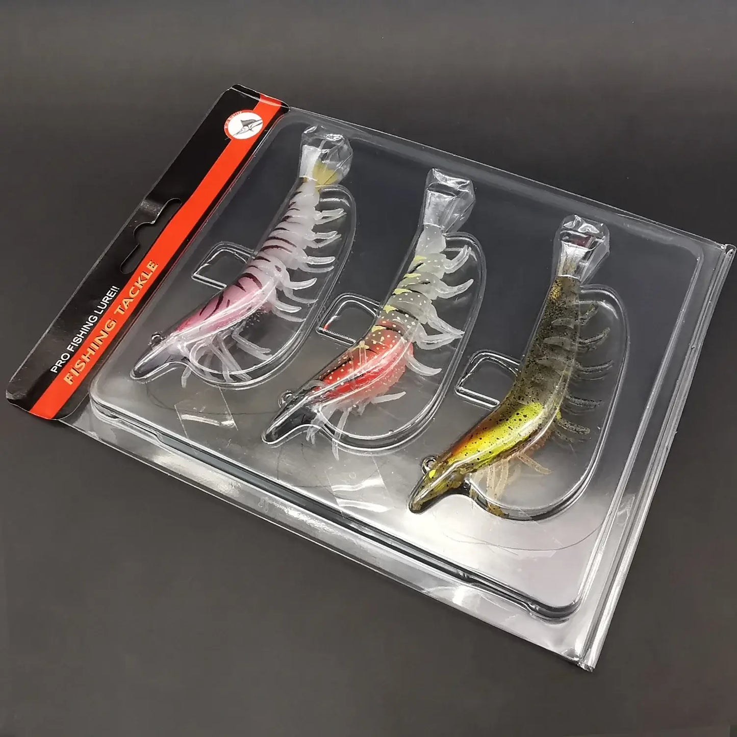 Set of 3 luminous soft bait prawn fishing lures in clear packaging, ideal for bass and trout fishing.