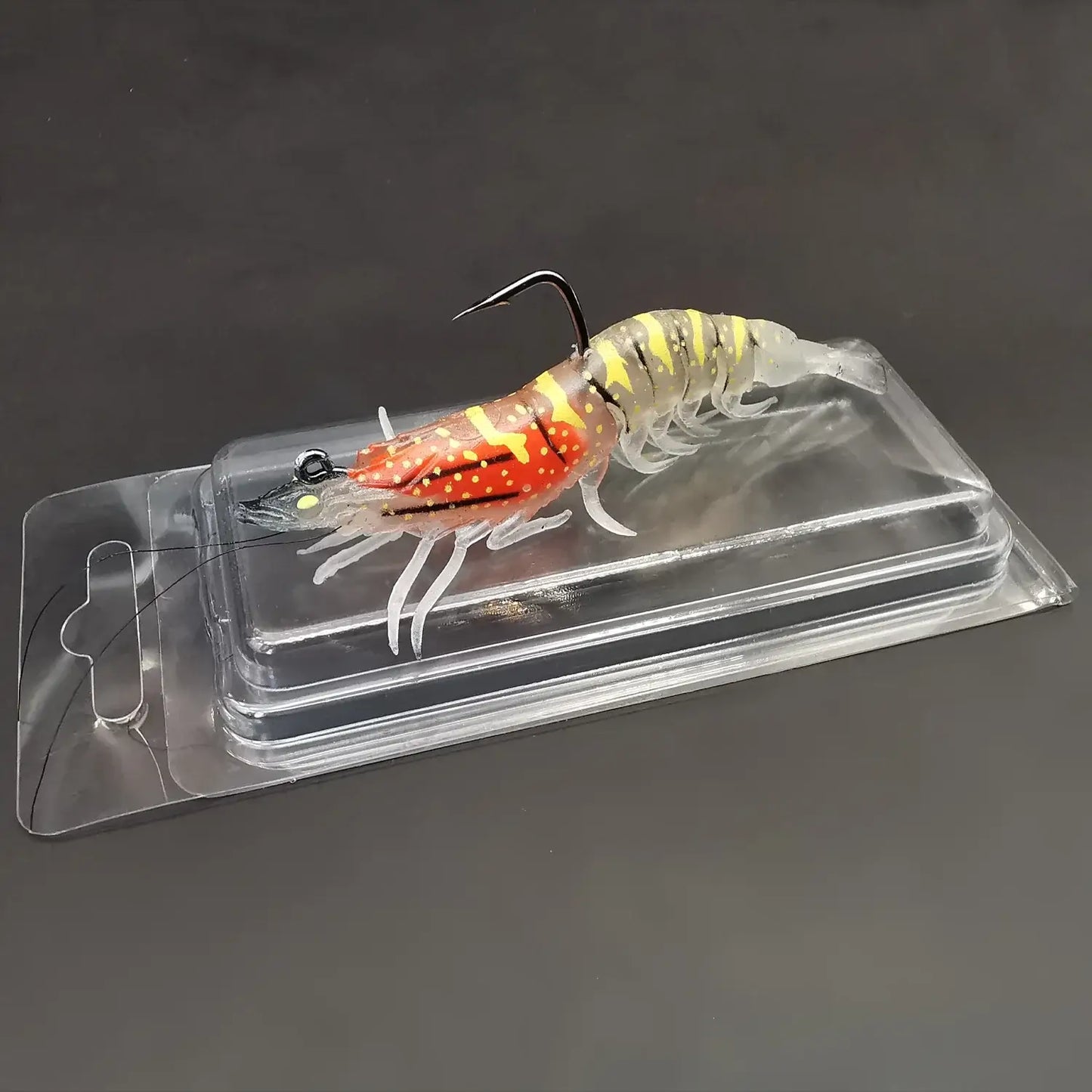 Luminous soft bait prawn fishing lure with pre-rigged fishing jig in packaging, ideal for bass and trout.