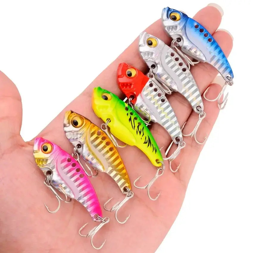 Colorful Aorace VIB fishing lures in hand, featuring various weights and vibrant designs for effective fishing.