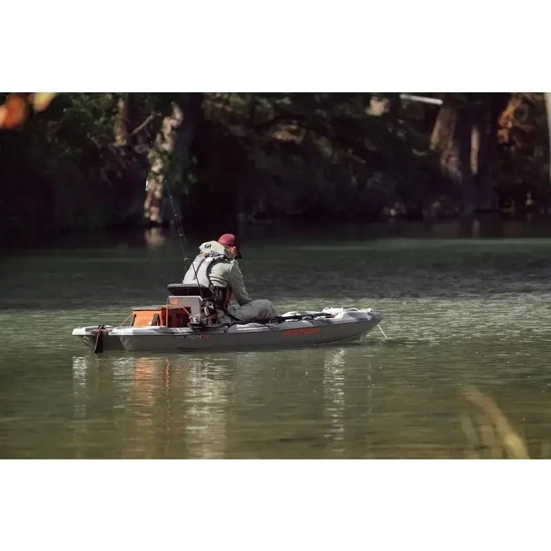 Angler fishing from the Catch Mode 110 Premium Kayak on a tranquil lake, showcasing stability and comfort.
